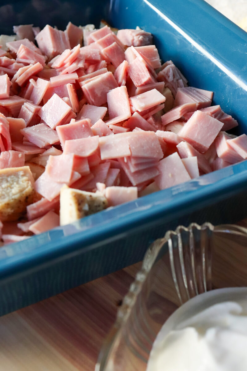Front view of a blue casserole dish filled with chicken and ham