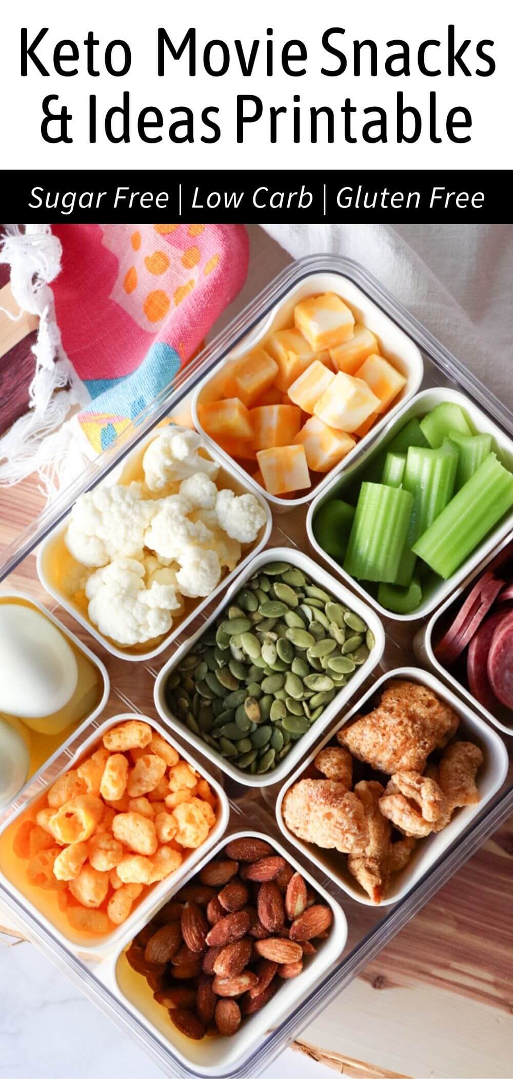 Keto movie snacks in a divided tray including cheese cubes, celery sticks, cauliflower, pumpkin seeds, almonds, pork rinds, cheese puffs, salami, and hard boiled eggs with text “Keto Movie Snacks & Ideas Printable – Sugar Free, Low Carb, Gluten Free”