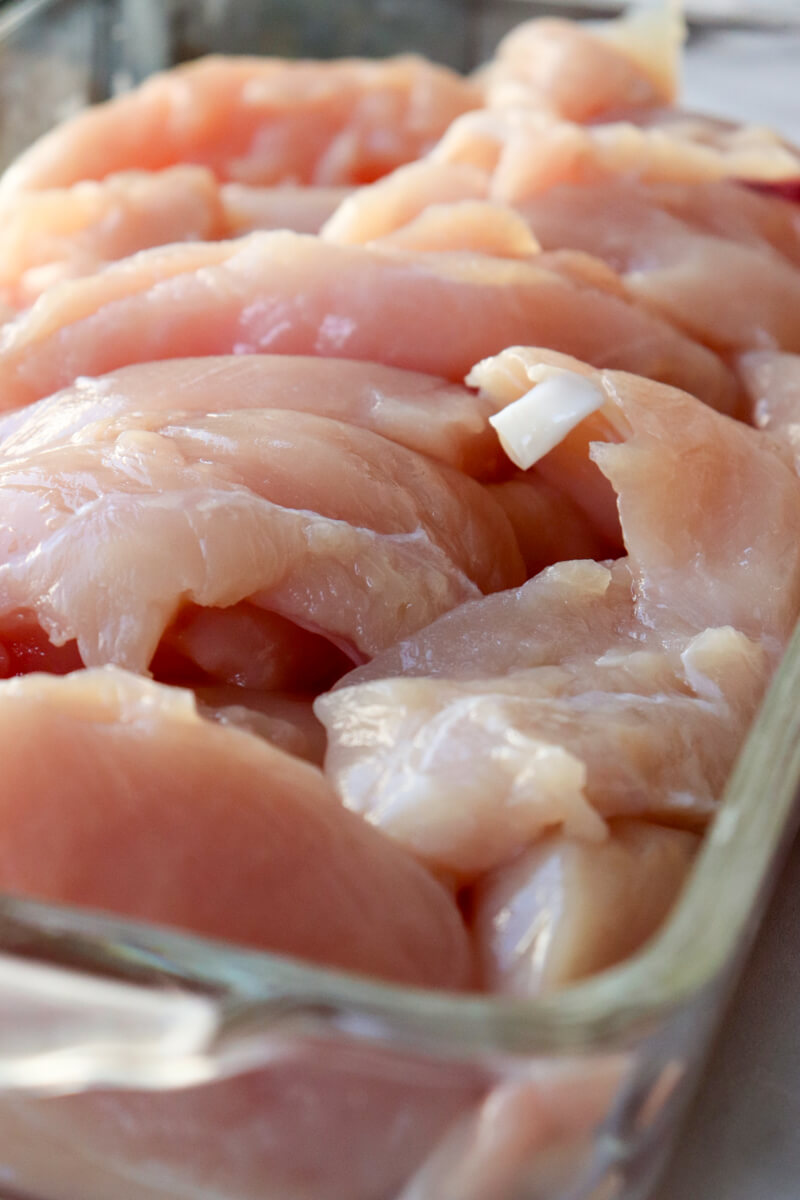 Rectangle glass Pyrex dish filled with raw chicken tenders