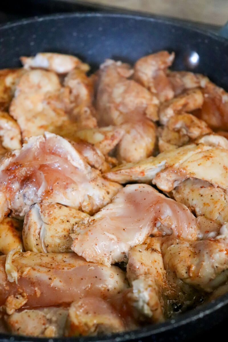 Close up of chicken tenders browning in the pan