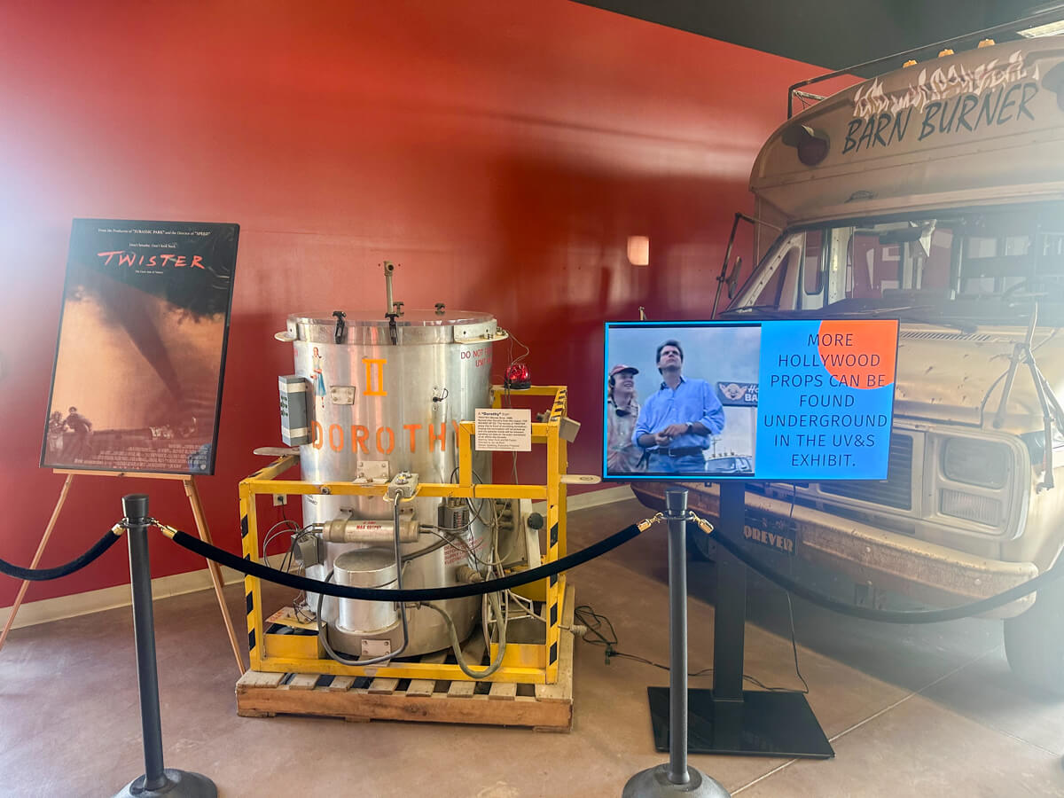 A poster from the original Twister movie with Dorothy and other props from the movie