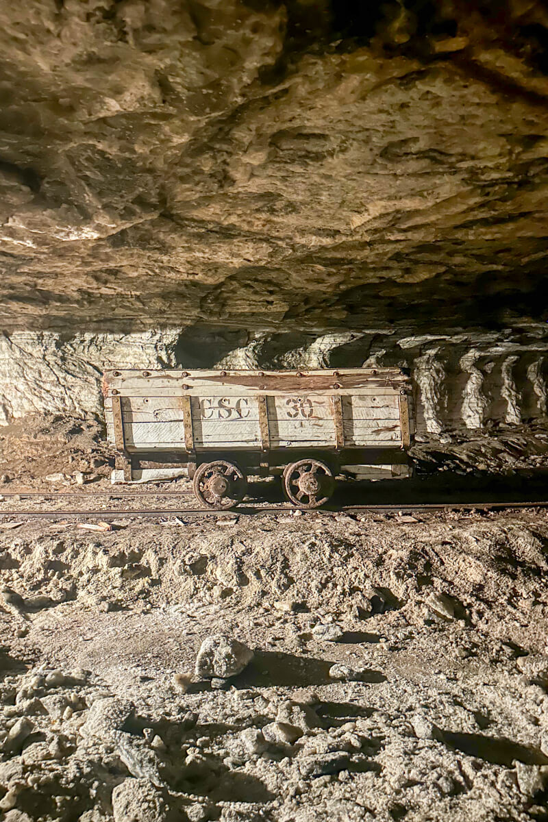Underground in the Strataca salt mine exhibit with a view of a salt car on train tracks