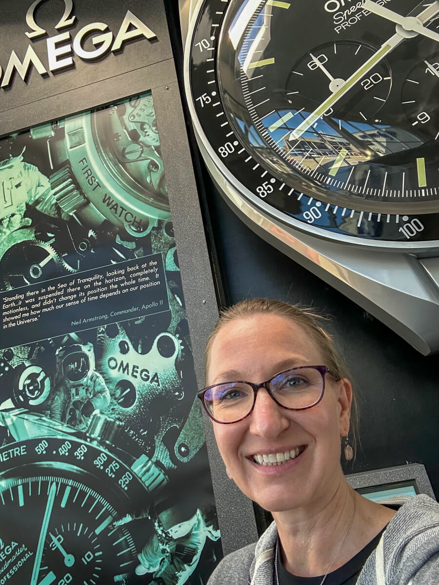 A woman in glasses in front of a watch exhibit at the Cosmosphere space museum in Hutchinson, Kansas