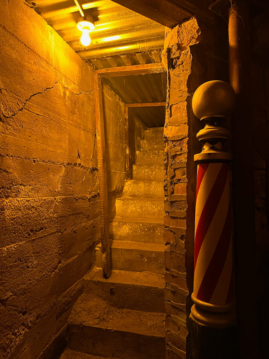 Underground tunnel staircase in Ellinwood Kansas with warm lighting and vintage barber pole