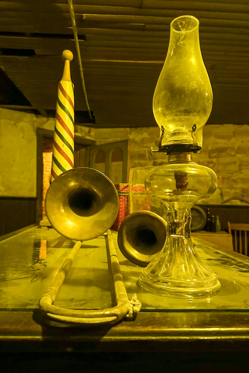 Doctor's office with kerosene lamp and instruments in an underground room in Ellinwood Kansas with warm lighting