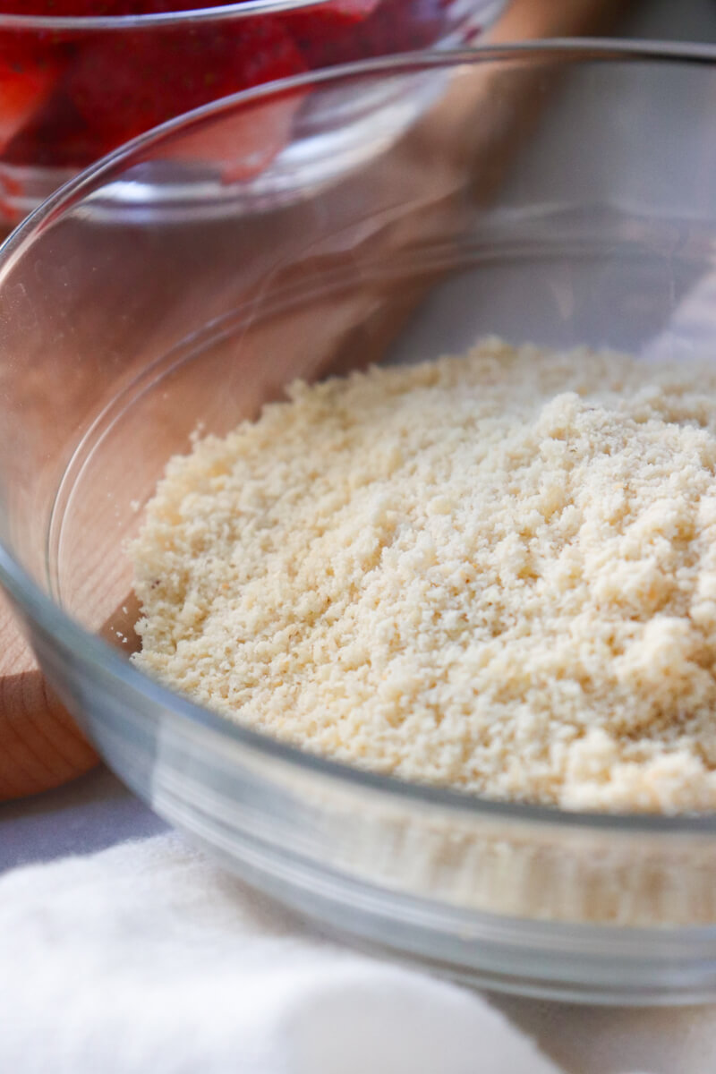 Clear class bowl of finely ground blanched almond flour.