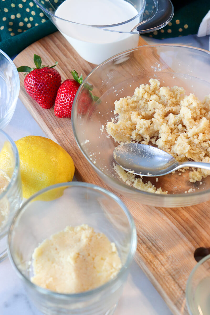 Overhead view of low carb almond flour crust ingredients next to some strawberries and a lemond.